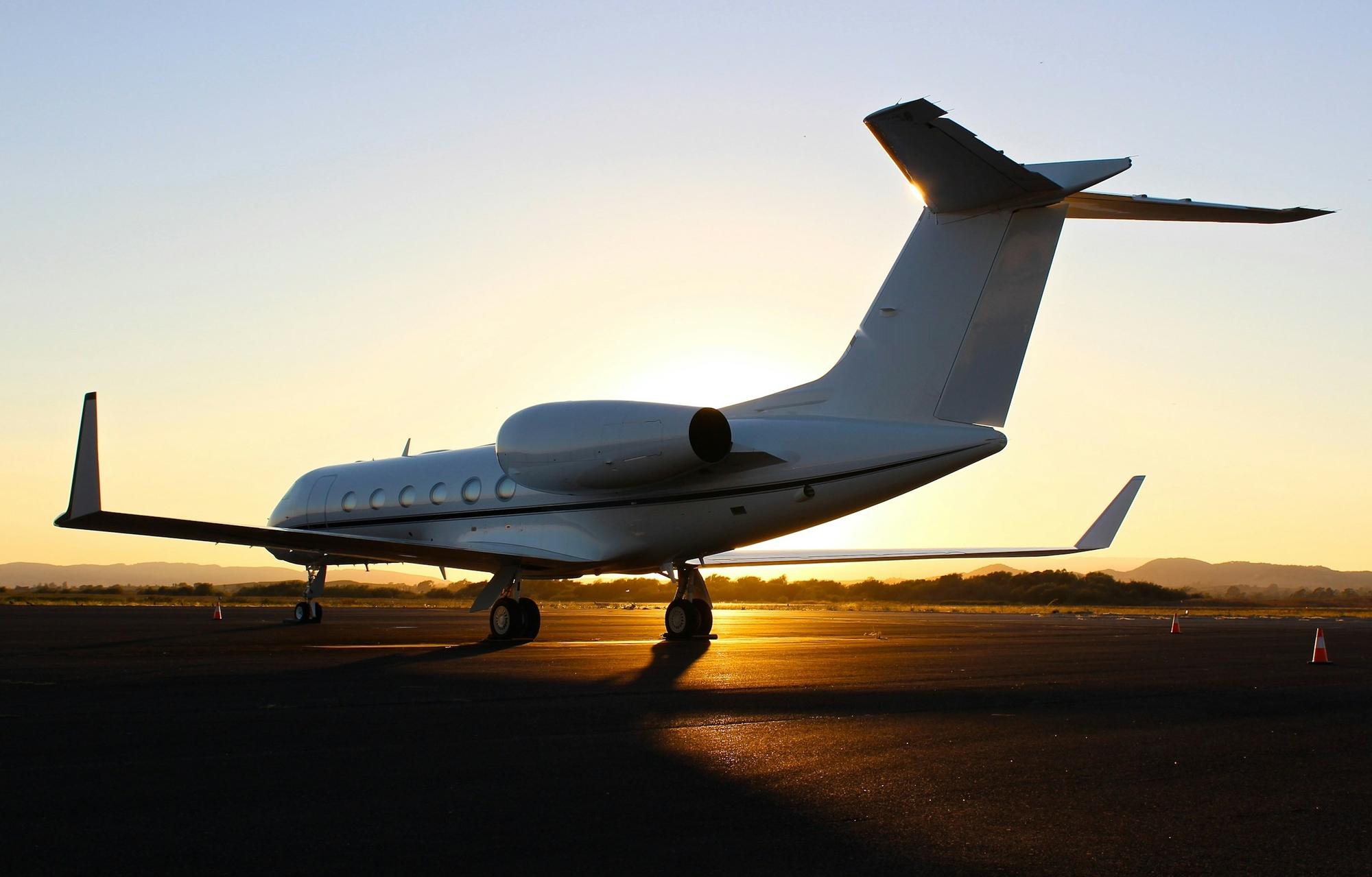 Gulfstream business jet on the ramp at sunset